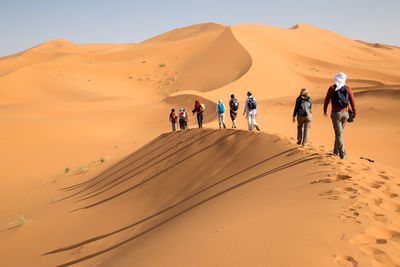 Tourists walking in desert