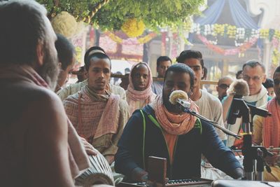 People sitting in traditional clothing