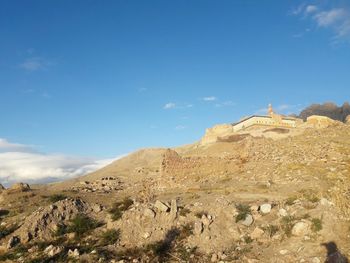 View of castle on mountain against blue sky