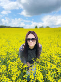 Young woman wearing sunglasses on field