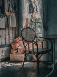 Empty chairs and table against window at home