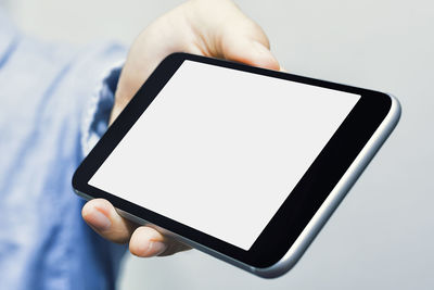 Low section of person holding mobile phone