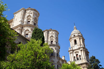 Low angle view of historic building against clear blue sky