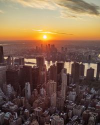 High angle view of modern buildings against sky during sunset