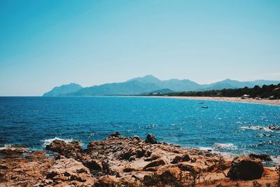 View of calm sea against clear blue sky