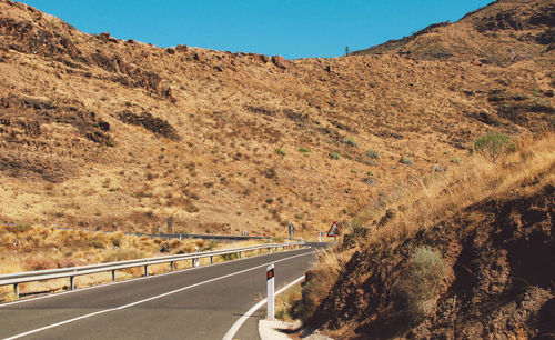 Mountain road against clear sky