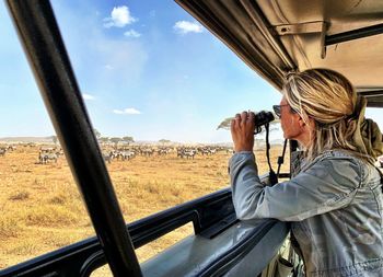 Woman photographing through car window