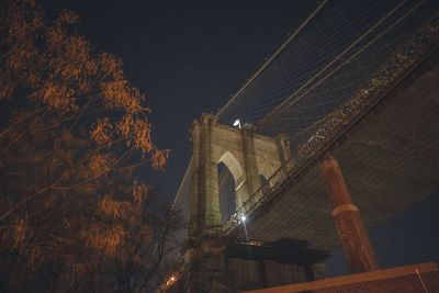 Low angle view of illuminated building against sky at night