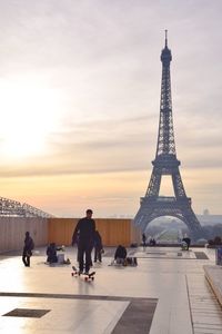 Tourists against cloudy sky