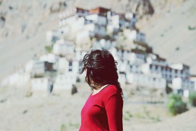 Woman standing in city during sunny day