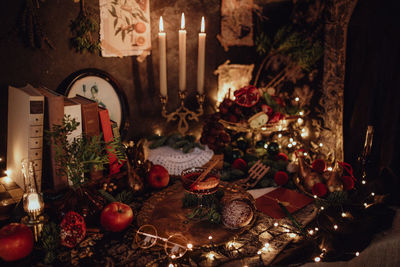 Christmas academia vintage harry potter table - fir, candles, wine, red decor, glasses, gingerbread