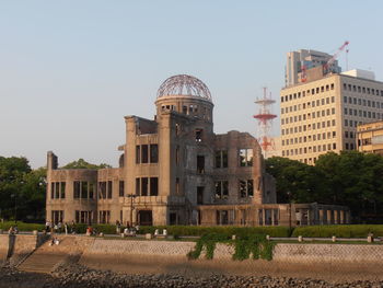 Buildings in city against clear sky