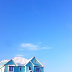 High section of building against blue sky