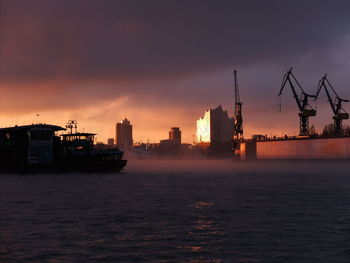 Boat in sea against sky during sunset