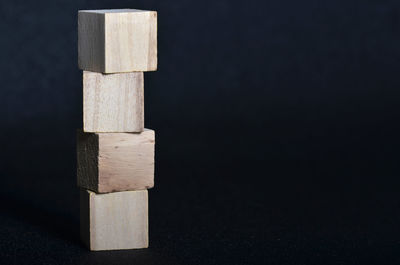 Close-up of stack of wood against black background