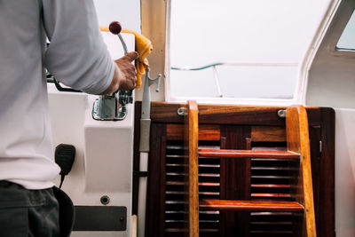 Midsection of man riding boat