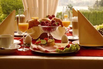 Close-up of fresh healthy breakfast served on table with juice