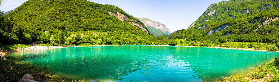 Scenic view of lake by trees against sky