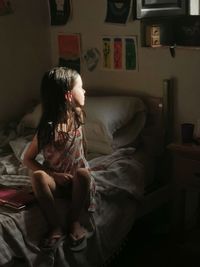 Young woman sitting on sofa at home