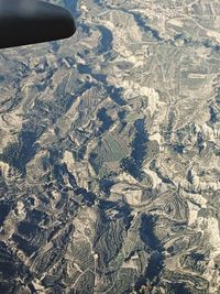 High angle view of airplane flying over land