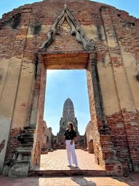 Rear view of woman standing outside building