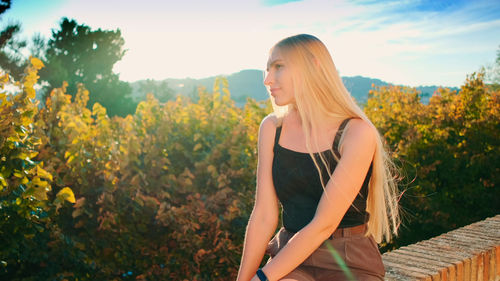 Young woman standing amidst plants