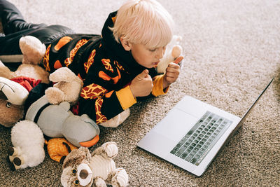 Young boy video conferencing with class on computer