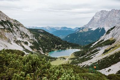 Scenic view of lake and mountains against sky