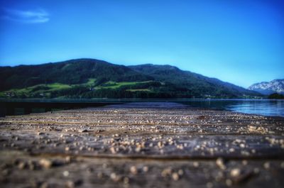 Surface level of river against clear blue sky