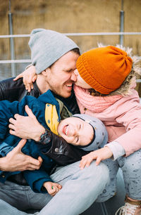 Father and two children walk in nature in autumn, spend time together, have fun.