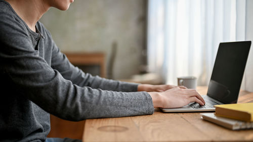 Midsection of businessman working at office