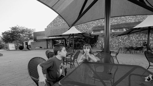 Boy sitting in front of building