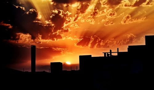 Low angle view of silhouette buildings against sky during sunset