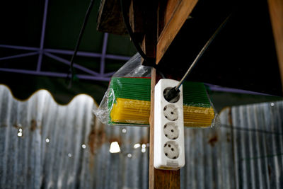 Close-up of yellow hanging on fence
