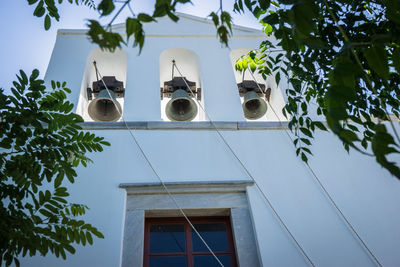 Low angle view of three bells on a chapel