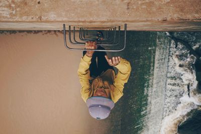 Man climbing up ladder