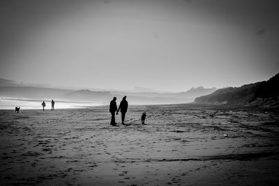 People on beach against sky
