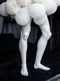 Low section of white sculpture against building