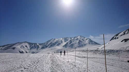 Scenic view of snowcapped mountain against blue sky