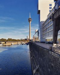 View of buildings by river in city