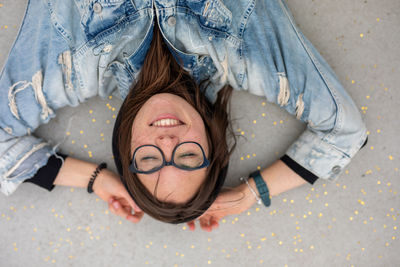 High angle portrait of smiling woman lying down