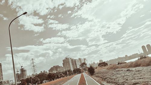 Road amidst trees against sky