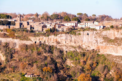 High angle view of buildings in town against sky