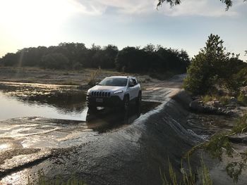 Car on landscape against sky