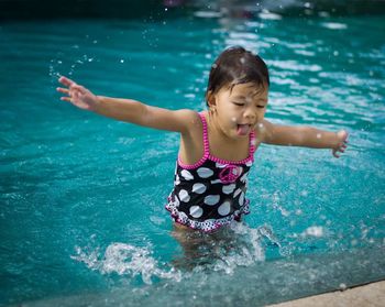 Portrait of girl playing in swimming pool