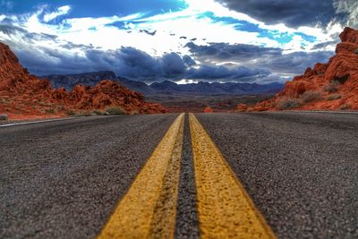 Surface level of empty road against sky