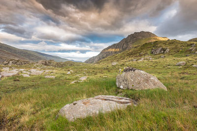 Scenic view of land and mountains against sky