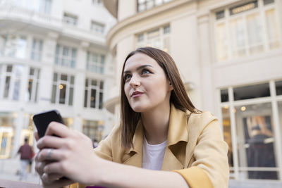 Portrait of beautiful young woman using mobile phone