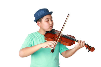 Full length of a boy playing guitar against white background