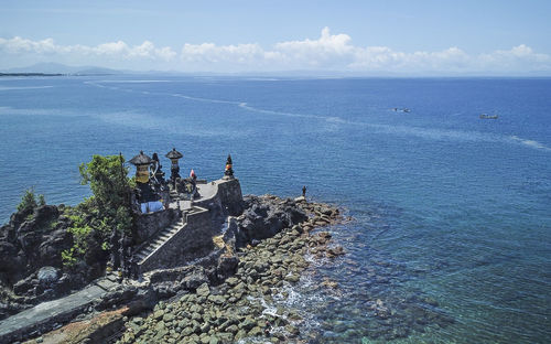High angle view of people in sea against sky